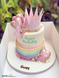 a birthday cake decorated with pink and purple flowers