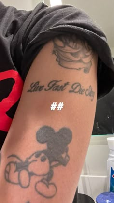 a person with a mickey mouse tattoo on their arm