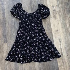 Black With Pretty Purple Flowers Brand New Has Tags... Nothing Is Wrong With It Xs But Fits Me Size Small If You Have A Bigger Chest, It May-Be A Little Tight Casual Purple Floral Dress For Spring, Black Mini Dress With Ditsy Floral Print, Spring Black Mini Floral Dress, Spring Black Floral Mini Dress, Black Floral Mini Dress For Spring, Fitted Black Floral Dress For Beach, Cute Purple Floral Print Mini Dress, Cute Purple Floral Mini Dress, Black Floral Short Sleeve Beach Dress