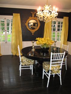 a dining room table with chairs and a chandelier