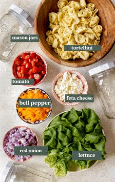 the ingredients for pasta salad laid out in bowls