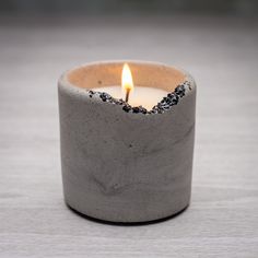 a lit candle sitting on top of a table