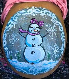 a pregnant belly painted with a snowman on it's side and pink top