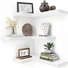 three white shelves filled with books and vases