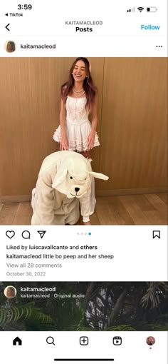 a woman standing next to a statue of a dog on top of a wooden floor