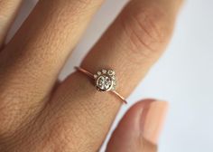 a woman's hand with a diamond ring on it