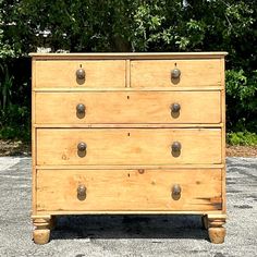 an old wooden chest of drawers with knobs