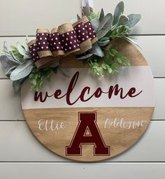 a wooden sign that says welcome to the team and has a wreath on top of it