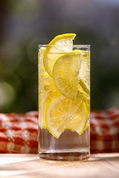 a glass filled with ice and lemon slices