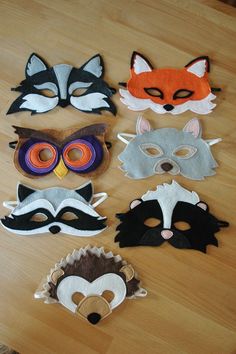 several masks are arranged on a wooden surface