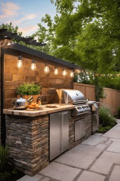 an outdoor kitchen with grill, sink and lights