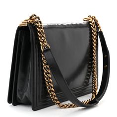 This is an authentic CHANEL Glazed Calfskin Large Boy Flap in Black. This chic shoulder bag is crafted of smooth luxurious glazed calfskin leather in black with a linear trim. The handbag features an aged brass chain shoulder strap with a leather shoulder pad, a Chanel logo stitched prominently on top, and a frontal unique Chanel boy push lock. This opens the front flap to a fabric interior with a zipper pocket. Chanel Logo, Chanel Boy, Aged Brass, Brass Chain, Shoulder Pads, Zipper Pocket, Calf Skin, Shoulder Strap, Chanel