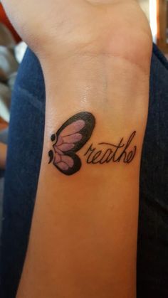 a small butterfly with the word breathe on it's left wrist tattoo design for girls