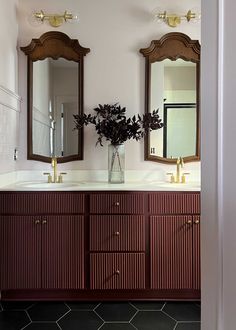 a bathroom with two sinks and mirrors on the wall