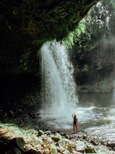 a person standing in front of a waterfall