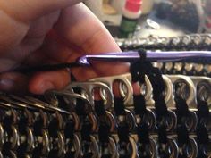 a person is crocheting the ends of two rows of chain - linked bracelets