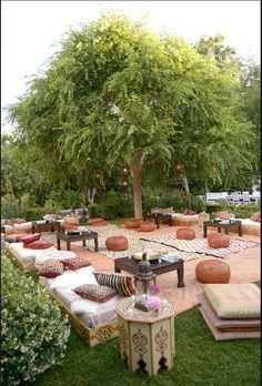 an outdoor seating area with pumpkins on the ground and tables set up in rows