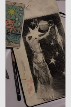 a pencil drawing of a woman with stars on her body and a tarot card next to it