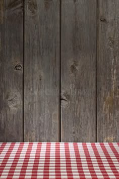 a red and white checkered table cloth on a wooden background royalty images, stock photos