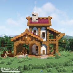 a house made out of wood and bricks in the middle of a field with trees