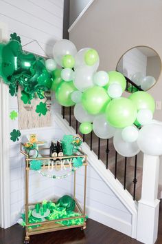 a staircase decorated with balloons and shamrocks for st patrick's day