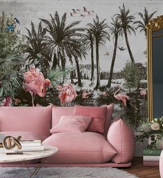 a living room with pink couches and wallpaper that has flamingos on it