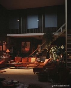 a living room filled with lots of furniture next to a stair case in front of a window