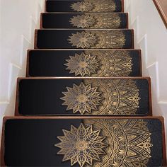 the stairs are decorated with intricate gold and black paper art work on each handrail