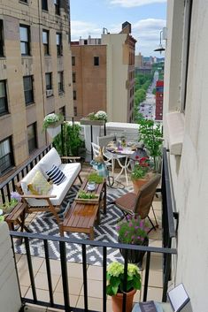 an apartment balcony with furniture and potted plants