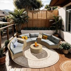 a circular couch sitting on top of a wooden floor next to a table and potted plants