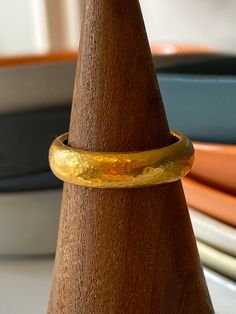 This gorgeous 22k gold band can only be described as subtle luxury. The color of 22k gold is incredibly warm and luscious. The band is hammered for strength. Makes a wonderful every day band and is spectacular in a stack. Please allow 3-4 weeks for turn around. Upcharge for bands over size 8.5. Free priority mail shipping with insurance and tracking. Dimensions: due to hand fabrication and hammering, each band varies slightly but is approximately 5mm wide and 3mm deep (high) See additional photo Hammered 22k Yellow Gold Rings, Gold Hammered Round Band For Wedding, Hammered Gold Wedding Band, Hammered Wedding Band, Hammered Wedding Bands, Subtle Luxury, Sapphire Band, Orange Sapphire, Over Size