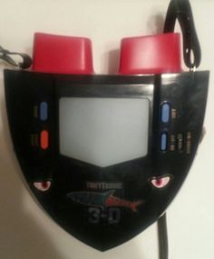 a black and red electronic device attached to a wall with two red knobs on it