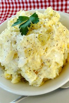 mashed potatoes topped with parsley on a white plate