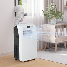 an air purifier sitting on top of a wooden floor next to a window