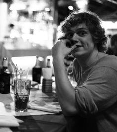 a person sitting at a table with drinks