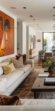 a living room filled with furniture and a painting on the wall above it's coffee table