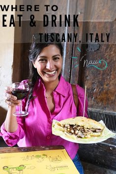 a woman holding a glass of wine and a plate with food on it in front of a sign that says where to eat & drink tuscany, italy