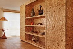 an empty room with wooden shelves filled with purses