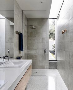 a bathroom with two sinks and a large mirror