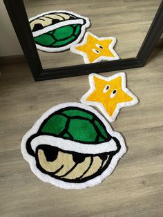 two rugs with cartoon characters on them in front of a mirror, one is green and the other has yellow stars