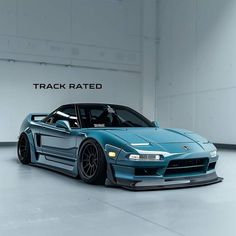 a blue sports car is parked in a garage with the words track rated on it