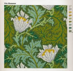 a cross stitch pattern with white flowers and green leaves on the bottom half of it