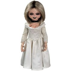 a creepy doll with white dress and black eyes