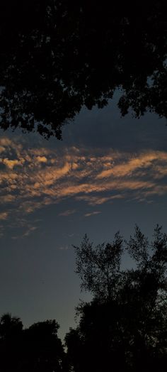 the sky is very dark and cloudy at night, with some clouds in the distance