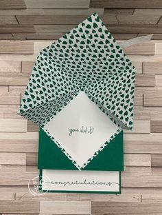 green and white folded cards with congratulations written on them