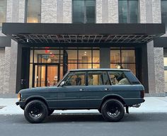 an suv parked in front of a building