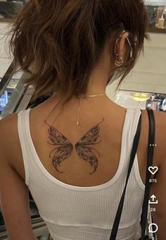 a woman with a butterfly tattoo on her back