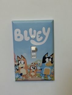 a light switch cover with cartoon characters on it and the word bluey written in white