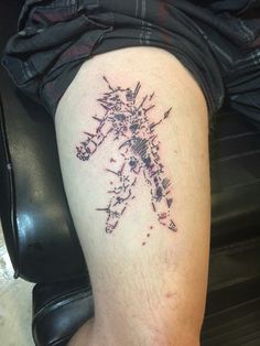 a man with a tattoo on his leg that has an image of a cross in it