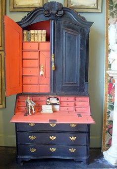 an old dresser has been painted red and black